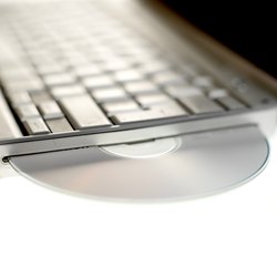 CD-DVD poking out of side of keyboard, close up