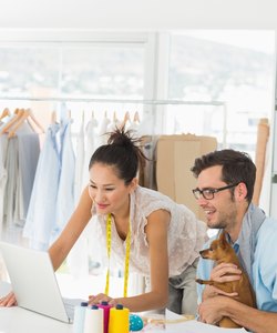 Fashion designers using laptop in studio