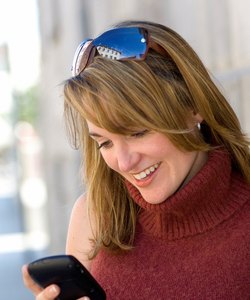 Women reading text on PDA.