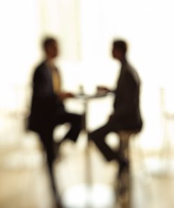 Blurred silhouette of businessmen at table