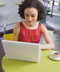 Woman using laptop at cafe
