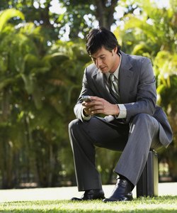 South American businessman sitting in park