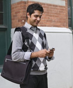 Business man texting on cell phone