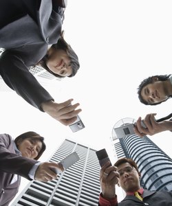 Low angle view of businesspeople with cell phones
