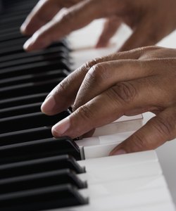 Close up of hands playing piano