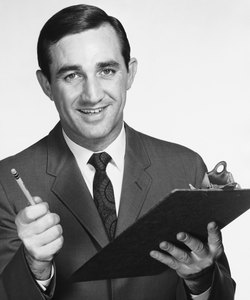 Man holding clipboard and pencil