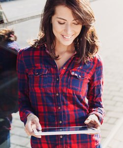 Girl using digital tablet outdoors