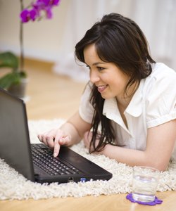 Young woman is playing on laptop