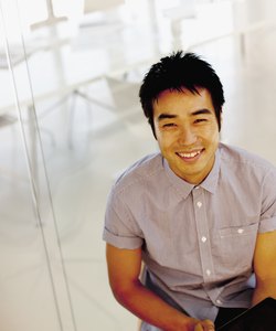 Portrait of smiling businessman using digital tablet in office