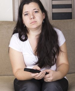 Young girl watching TV at home