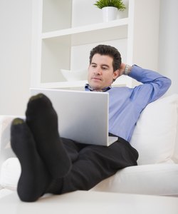 Mixed Race man looking at laptop