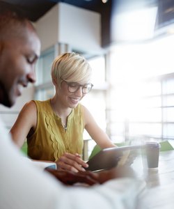 Two creative millenial small business owners working on social media