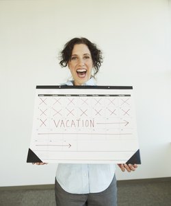 Businesswoman holding a calendar with her vacation marked on it
