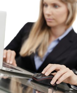 Beautiful young businesswoman using laptop