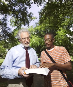 Professor helping student outdoors