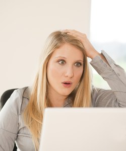 Shocked blond young woman in office