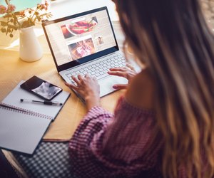 Female food blogger using laptop and working from home