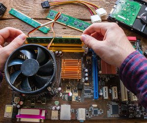 man repairing computer hardware