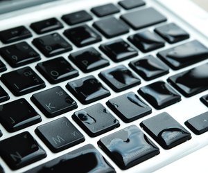 Computer laptop with water drop damage liquid wet and spill on keyboard