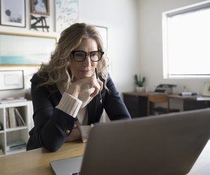 Senior businesswoman entrepreneur working at laptop in studio office