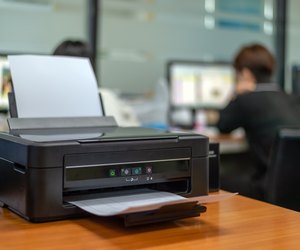 black printer in office with soft-focus and over light in the background