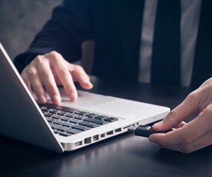 Businessman using flash drive connect to laptop