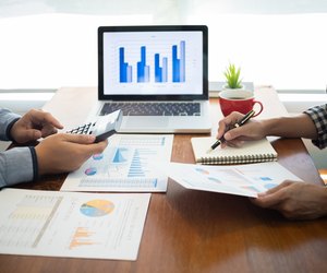 executives negotiating on business agreement with valuation of stock market.