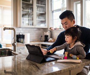 Father working in kitchen with daughter