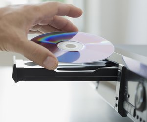 Man inserting dvd