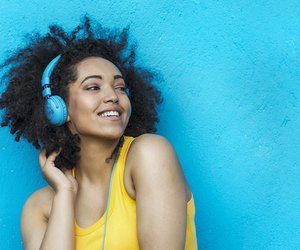 Woman in yellow vest and blue headphones