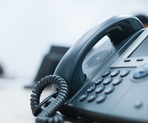close up soft focus on telephone devices at office desk for customer service support concept
