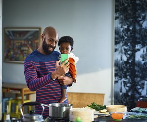 Man with baby son (6-11 months) at home