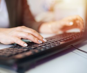 Businesswoman using desktop PC at office