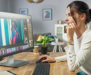 Professional Female Photographer Works in Photo Editing App / Software on His Personal Computer. Photo Editor Retouching Photos of Beautiful Girl. Mock-up Software Design.