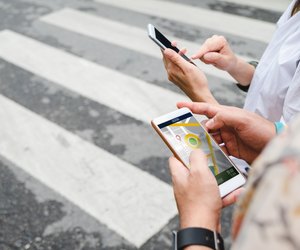 Traveler use map on mobile phone app to search for route location of place with gps on street when travel in city,Technology in lifestyle .