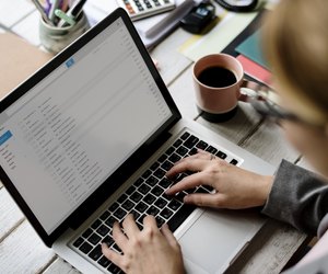 Businesswoman Checking E-mail Online on Laptop