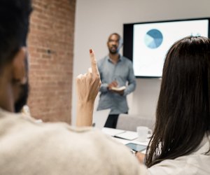 Young man has a presentation with the graph on an LCD screen