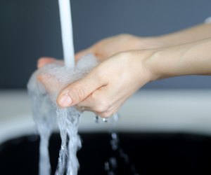 Woman washing hands in washstand