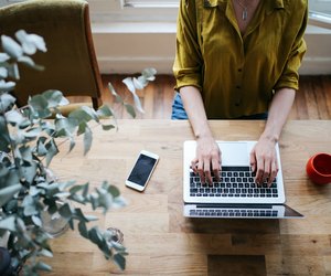 Overhead image of a female blogger writing on the laptop