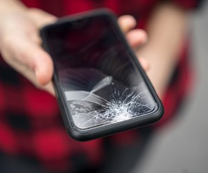 Broken phone in a female hand