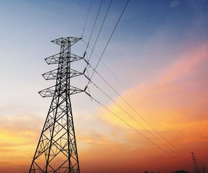 Low Angle View Of Silhouette Electricity Pylon Against Dramatic Sky During Sunset