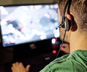 Man playing video game in dark room