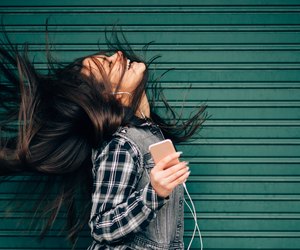 Teenage girl listening to the music and shaking head