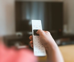 Cropped Hand Using Television Set Remote Control At Home