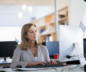 Confident businesswoman using computer in office