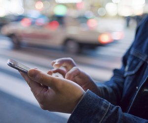 A man uses a mobile phone at Shibuya crossing