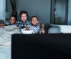 Family having popcorn while watching TV
