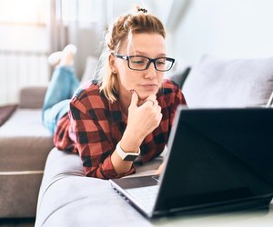 Pretty woman with laptop working at home