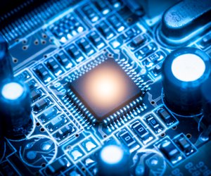 The abstract image of the chipset illumination on the computer mainboard. The concept of computer, hardware, futuristic, electronics and technology.