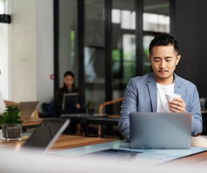 young chinese business people working with laptop
